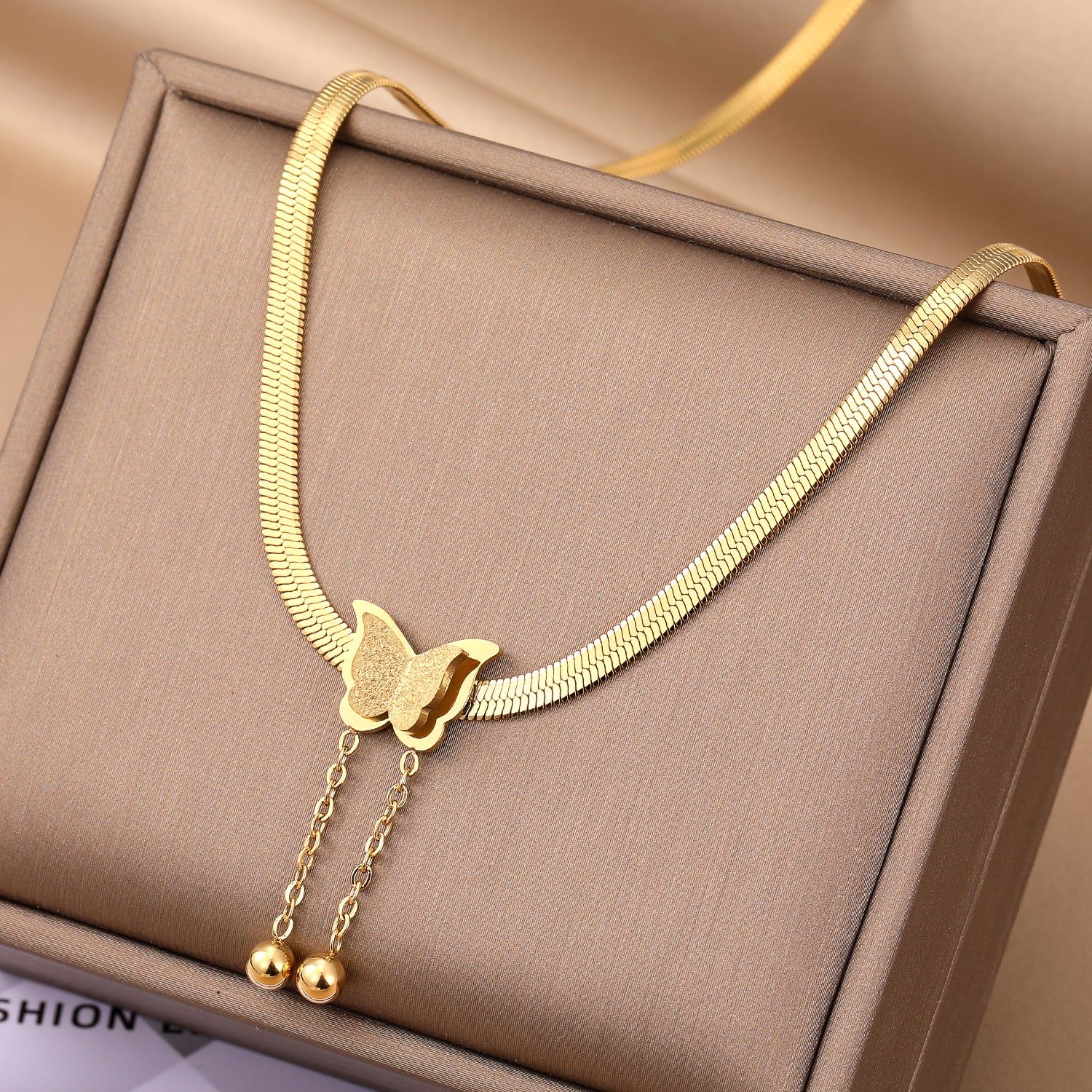 Elegant close-up of Butterglow Necklace displayed on a velvet stand
