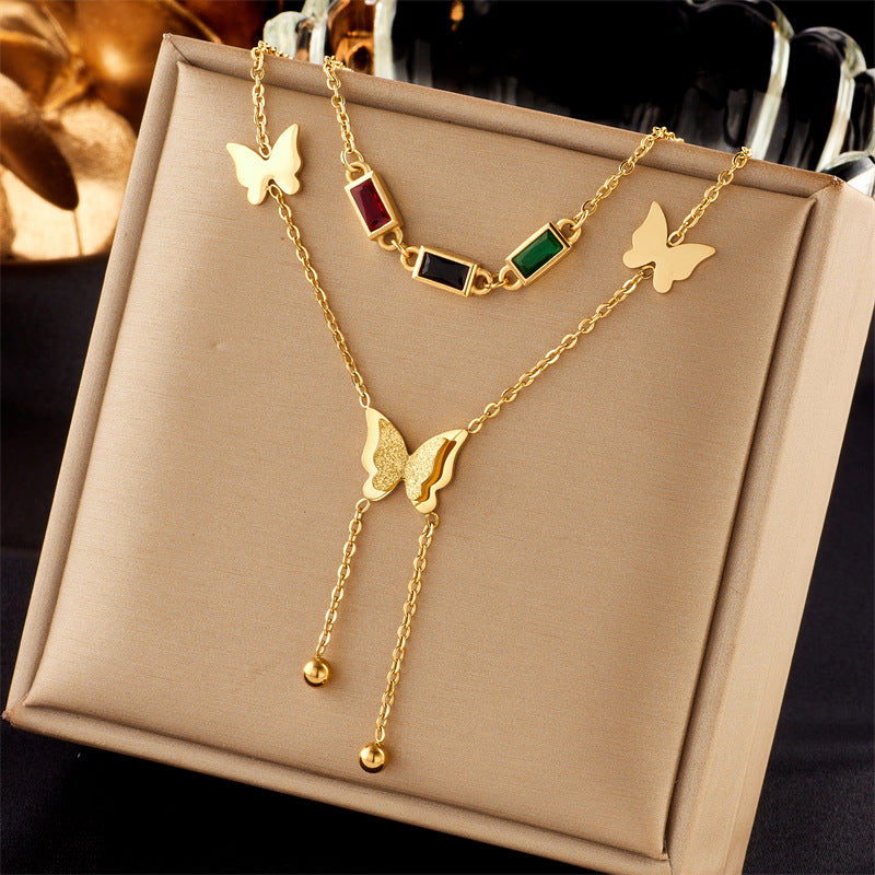 Elegant close-up of Golden Wings Necklace displayed on a velvet stand