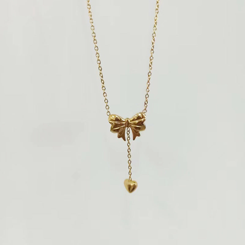Elegant close-up of Golden Grace Sweetheart Necklace displayed on a velvet stand