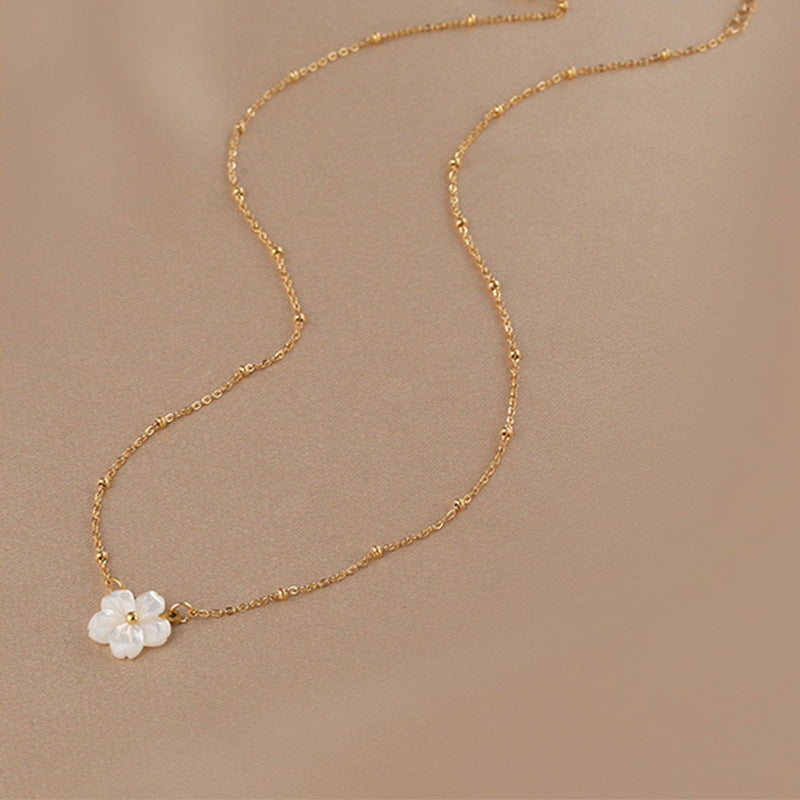 Elegant close-up of Golden Blossom Necklace displayed on a velvet stand