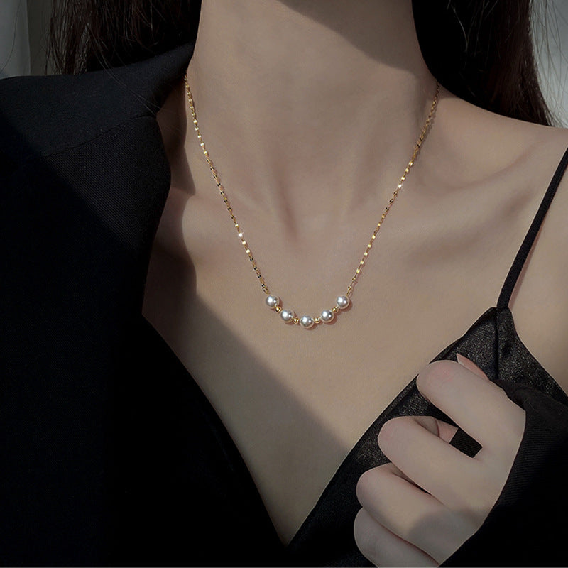 Elegant close-up of Golden-Pearl Grace Necklace displayed on a velvet stand