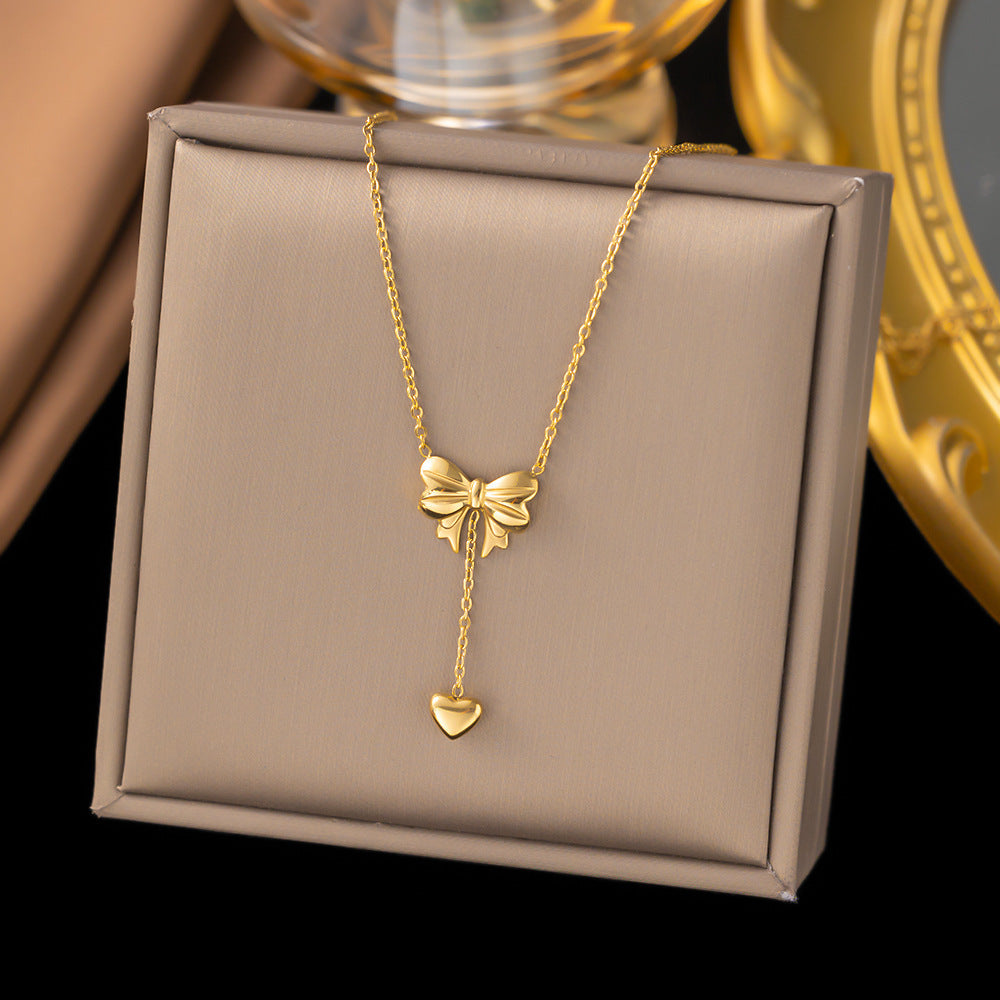 Elegant close-up of Golden Grace Sweetheart Necklace displayed on a velvet stand