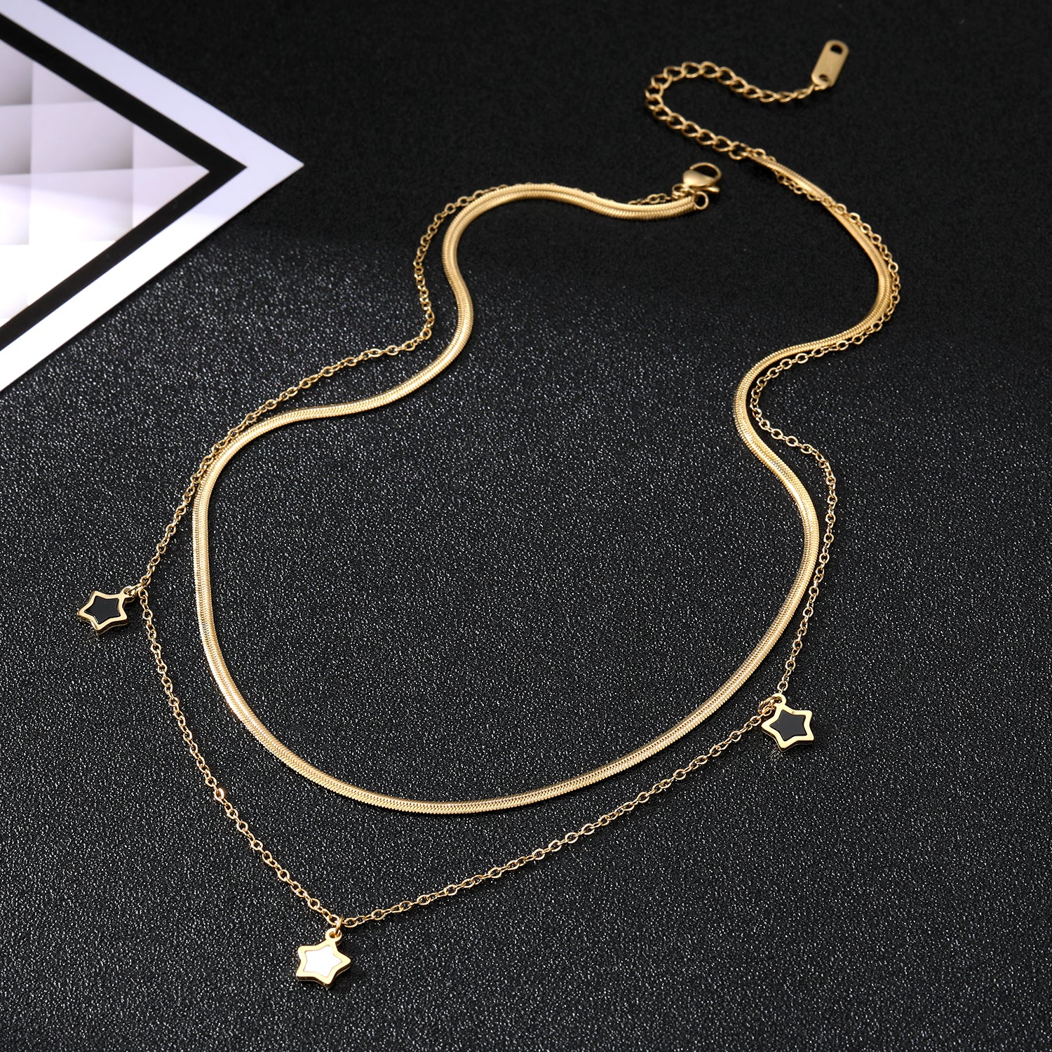 Elegant close-up of Stella Charm Necklace displayed on a velvet stand
