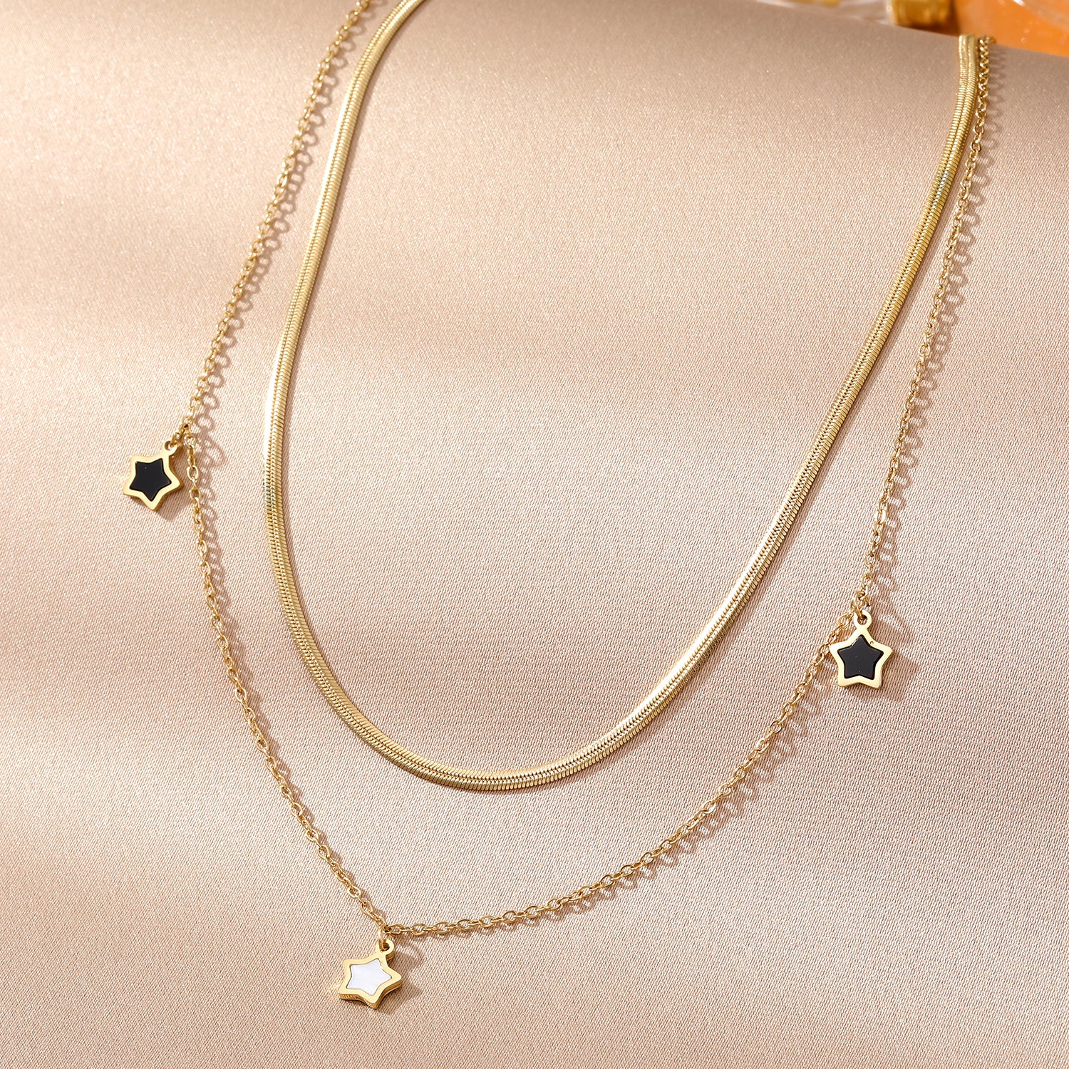 Elegant close-up of Stella Charm Necklace displayed on a velvet stand