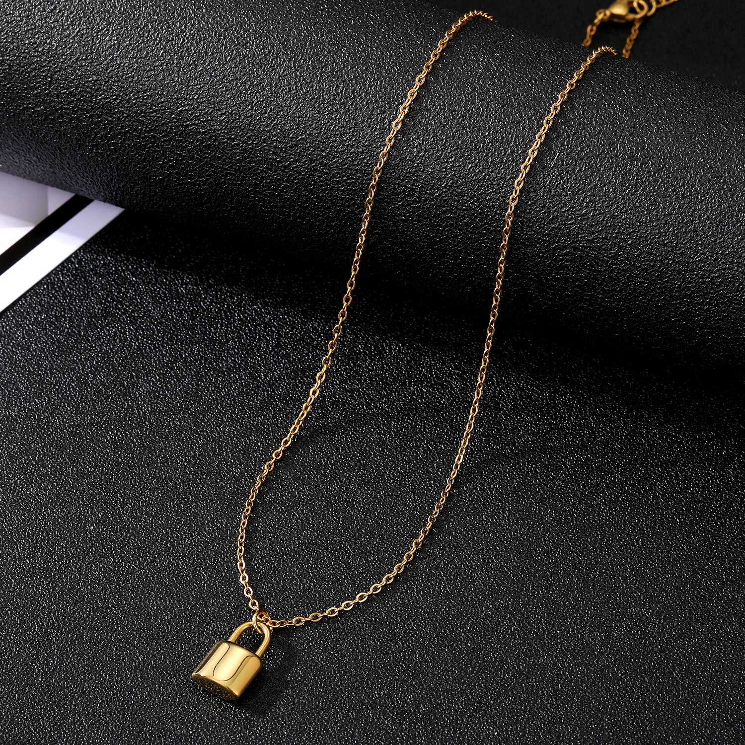 Elegant close-up of Golden Lockette Necklace displayed on a velvet stand