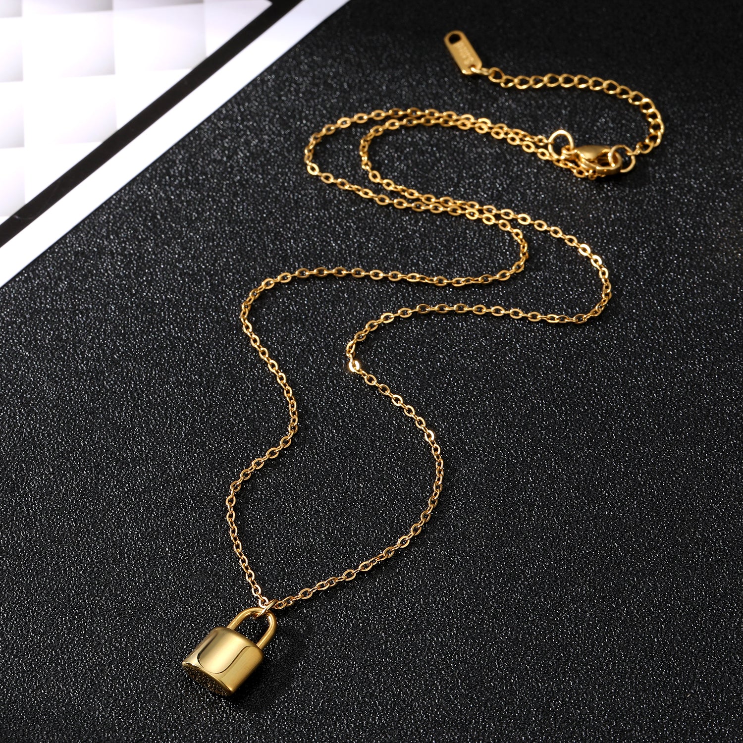 Elegant close-up of Golden Lockette Necklace displayed on a velvet stand