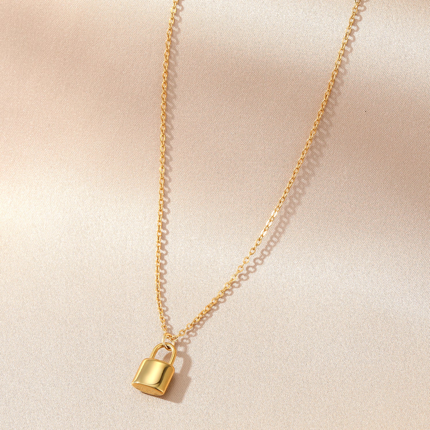 Elegant close-up of Golden Lockette Necklace displayed on a velvet stand