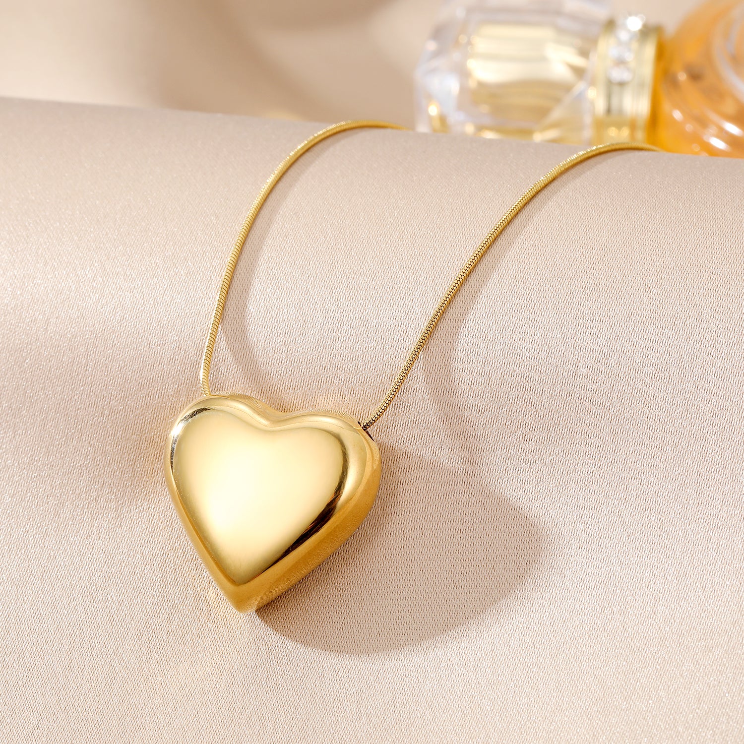 Elegant close-up of Golden Heart Necklace displayed on a velvet stand