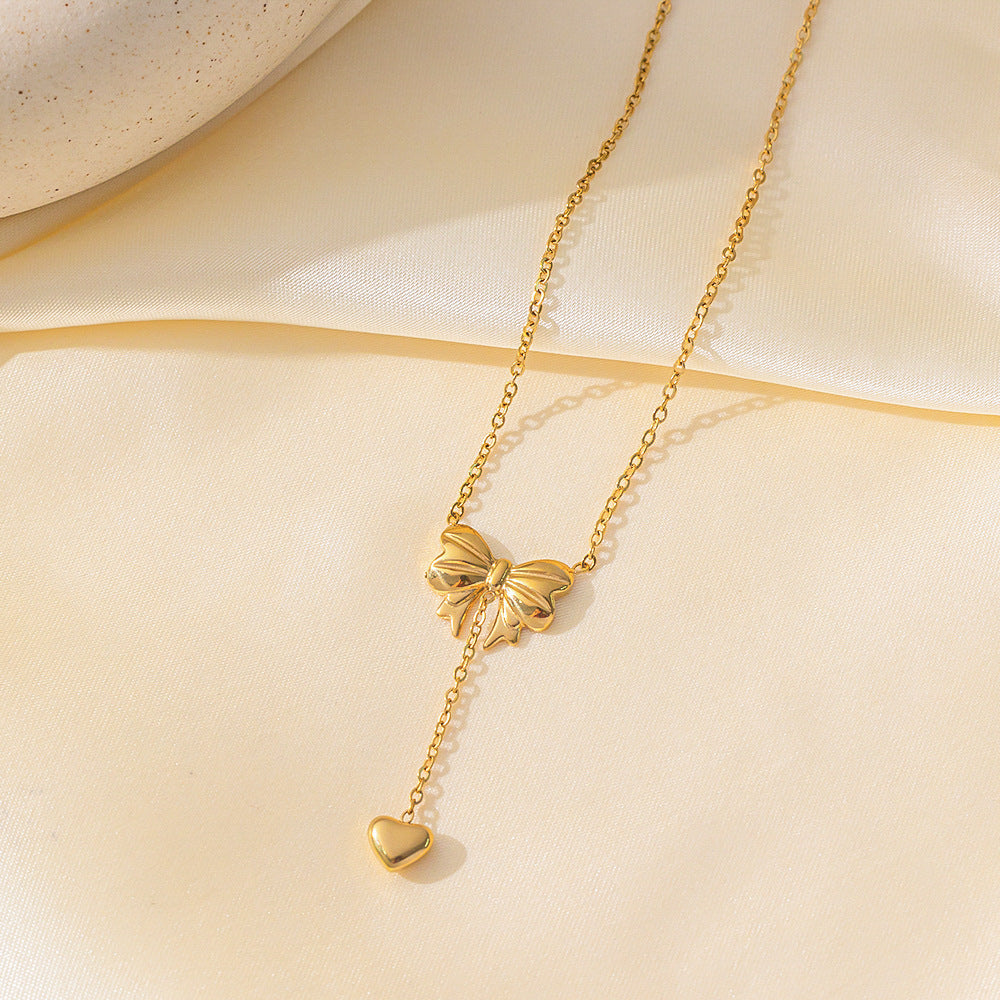 Elegant close-up of Golden Grace Sweetheart Necklace displayed on a velvet stand