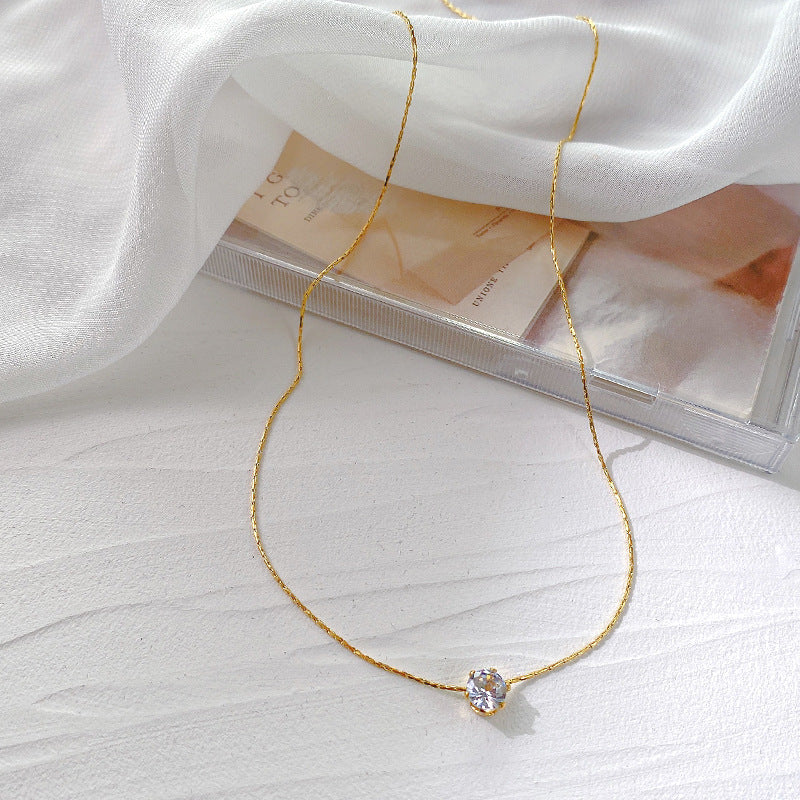 Elegant close-up of Sol Glow Necklace displayed on a velvet stand