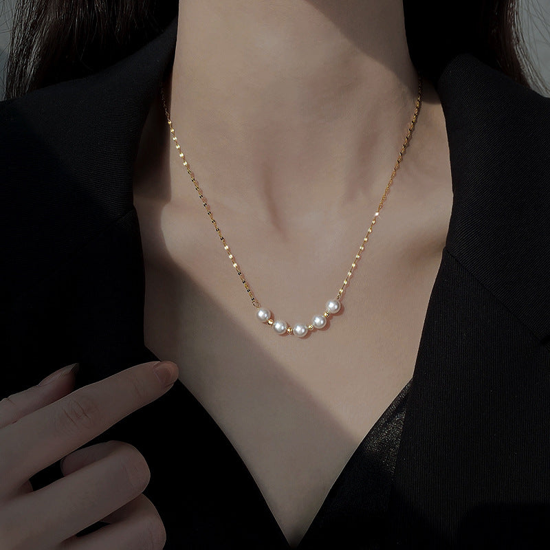 Elegant close-up of Golden-Pearl Grace Necklace displayed on a velvet stand