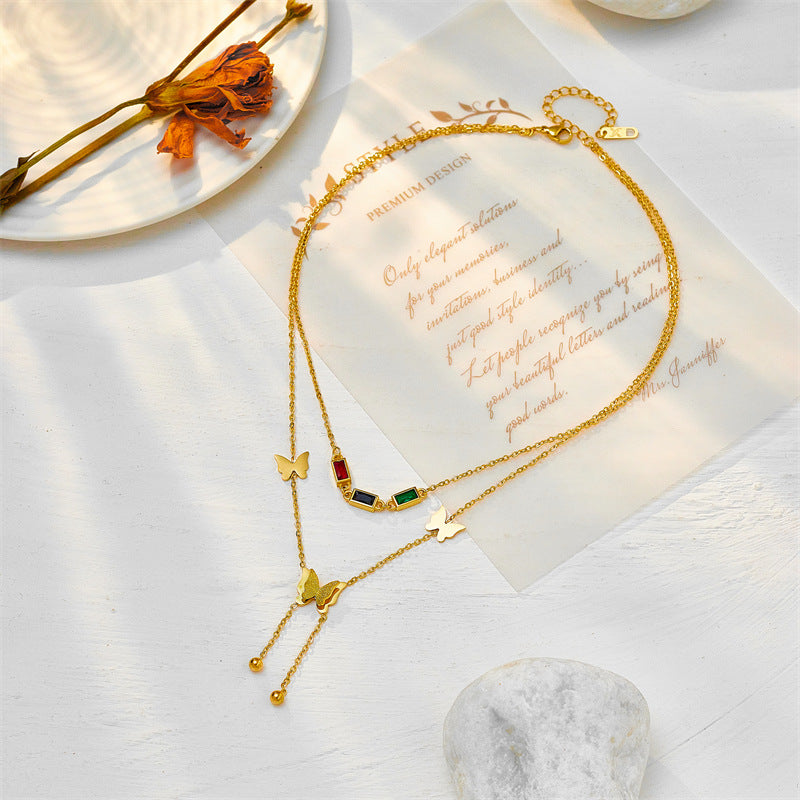 Elegant close-up of Golden Wings Necklace displayed on a velvet stand