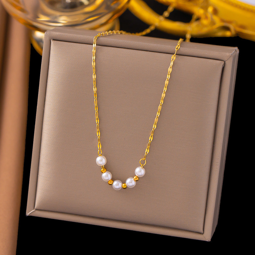 Elegant close-up of Golden-Pearl Grace Necklace displayed on a velvet stand