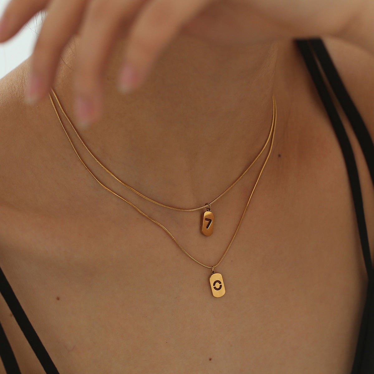 Elegant close-up of Golden Six Necklace displayed on a velvet stand