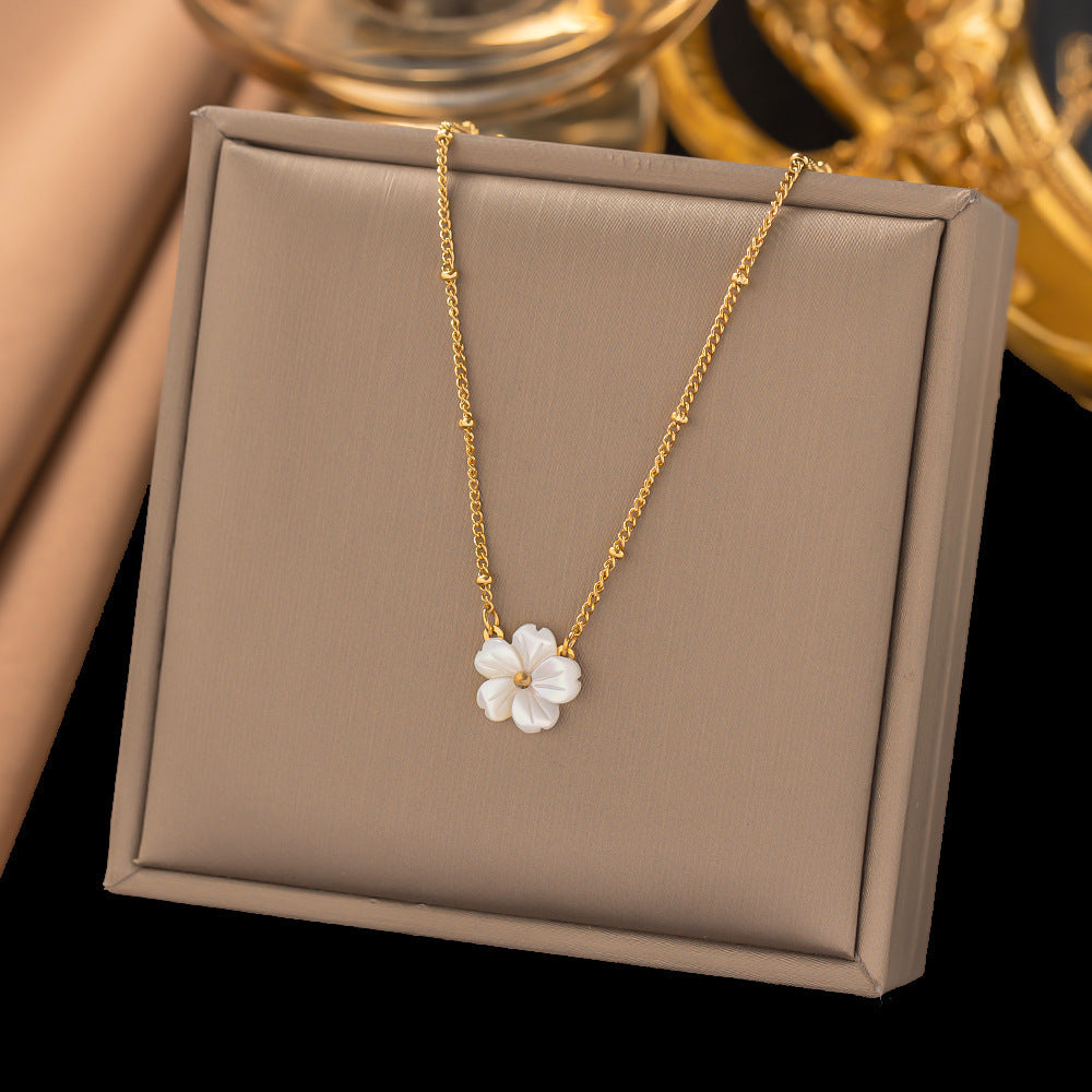 Elegant close-up of Golden Blossom Necklace displayed on a velvet stand