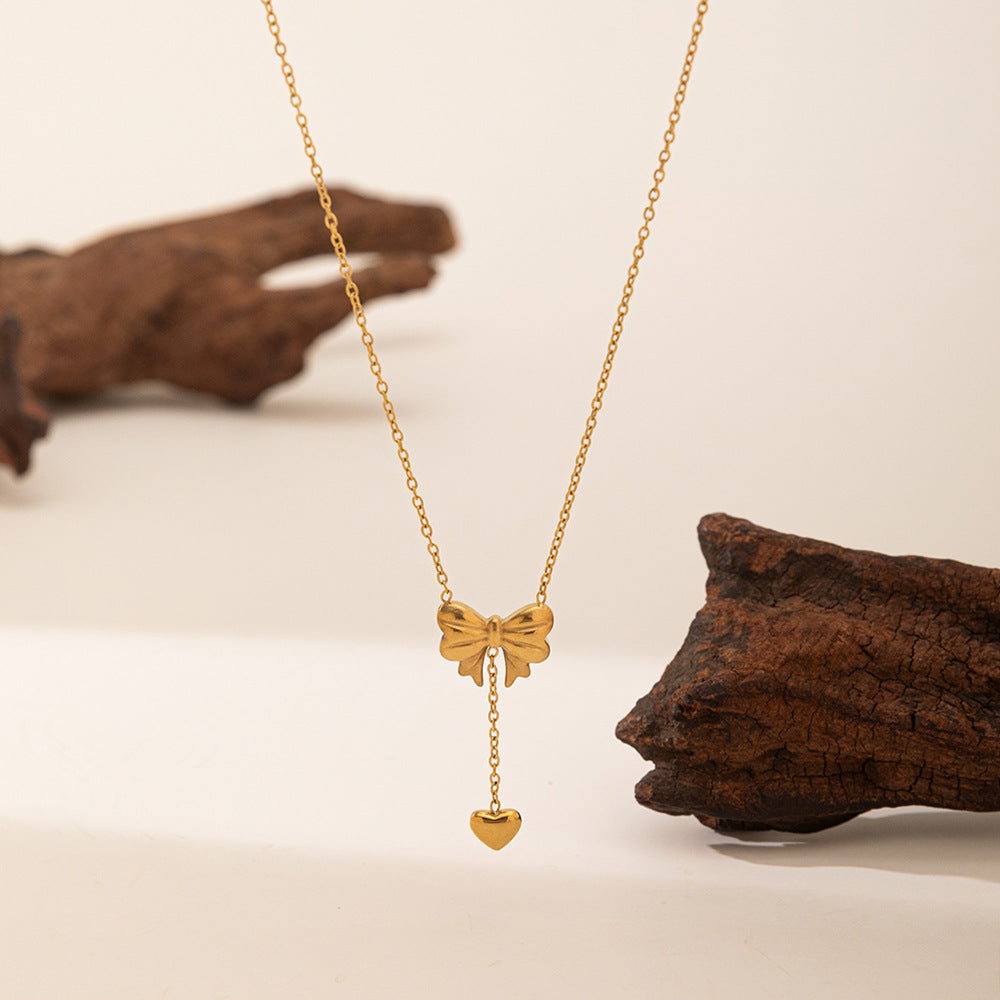 Elegant close-up of Golden Grace Sweetheart Necklace displayed on a velvet stand