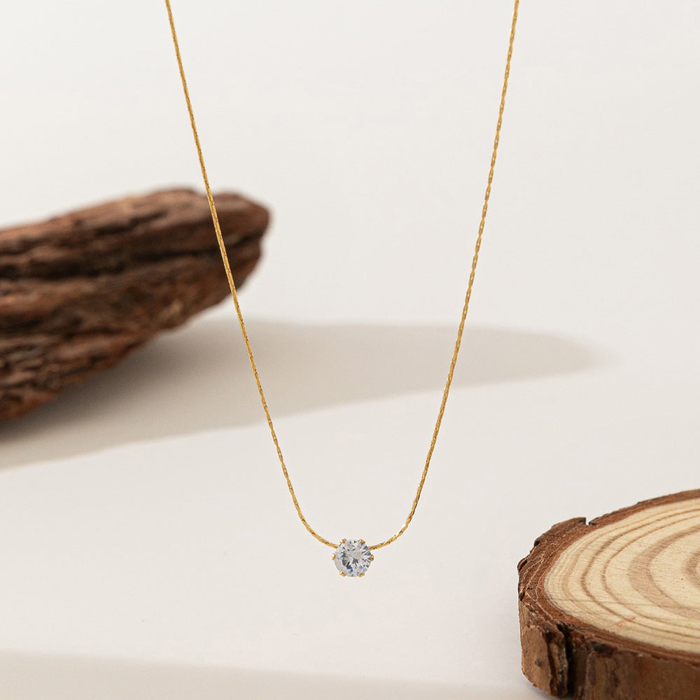 Elegant close-up of Sol Glow Necklace displayed on a velvet stand