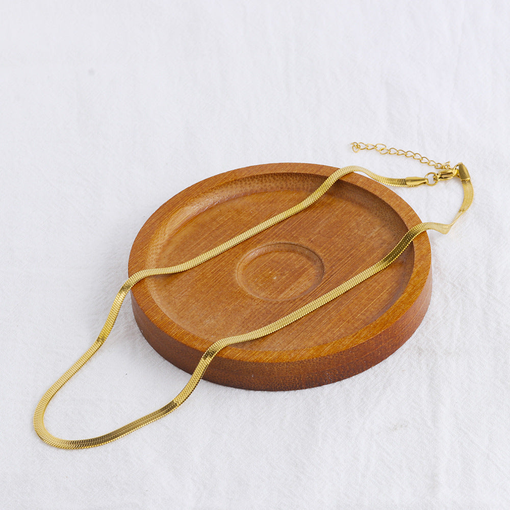 Elegant close-up of Golden Sleek Velvet Necklace displayed on a velvet stand