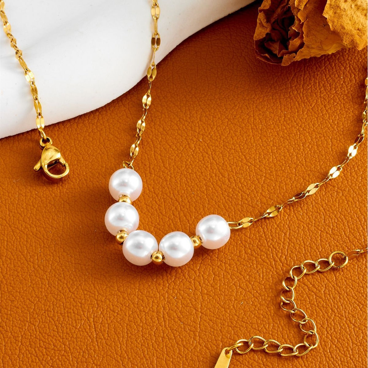 Elegant close-up of Golden-Pearl Grace Necklace displayed on a velvet stand