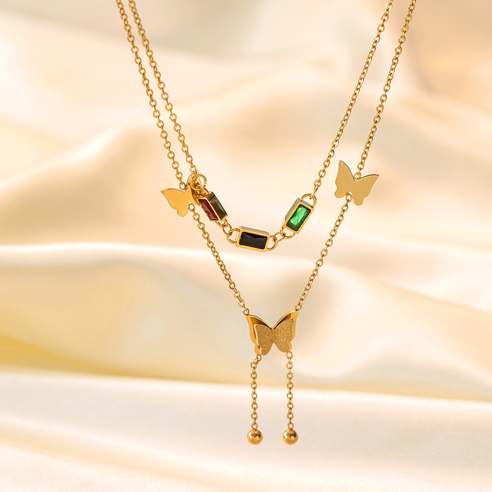 Elegant close-up of Golden Wings Necklace displayed on a velvet stand