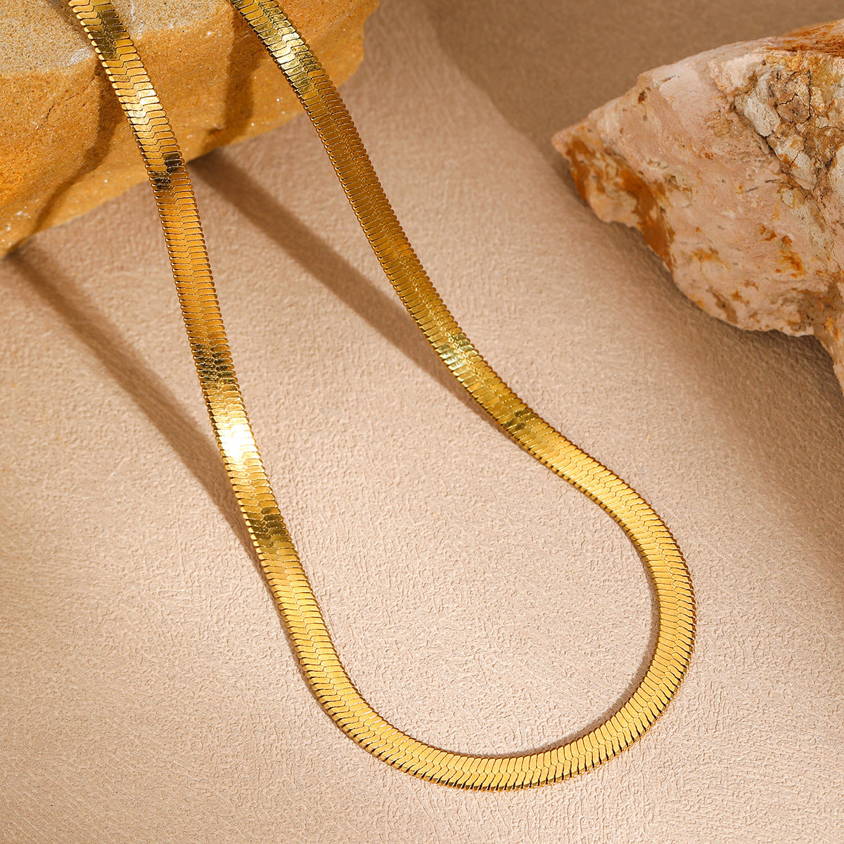 Elegant close-up of Gold Lume Chain displayed on a velvet stand