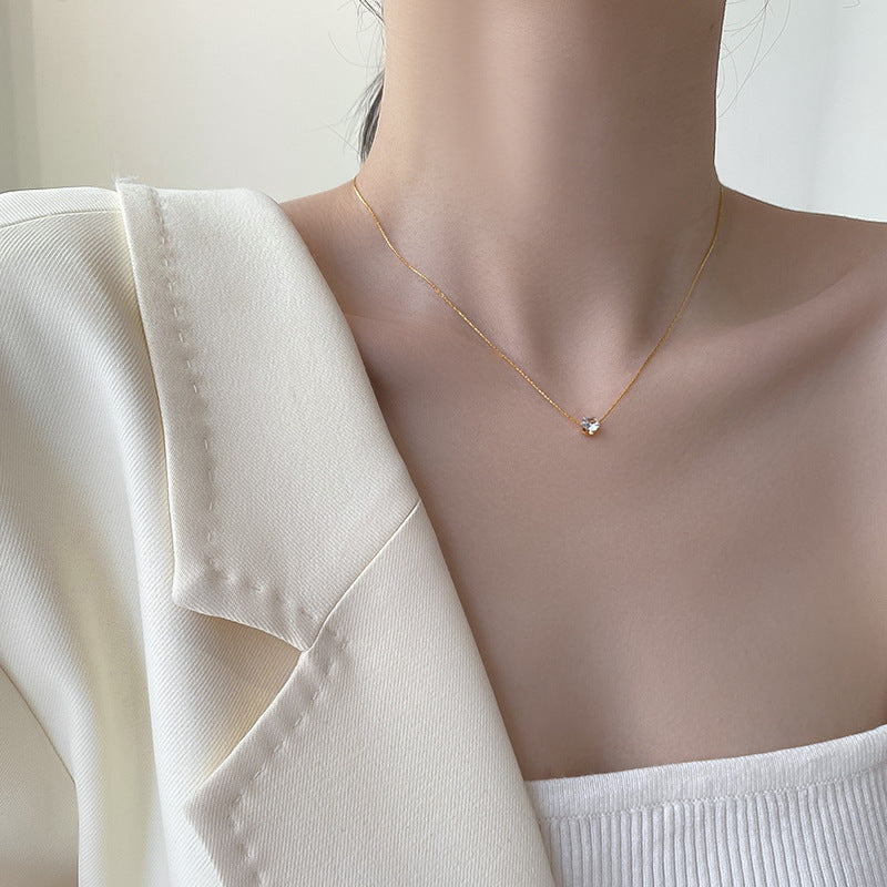 Elegant close-up of Sol Glow Necklace displayed on a velvet stand