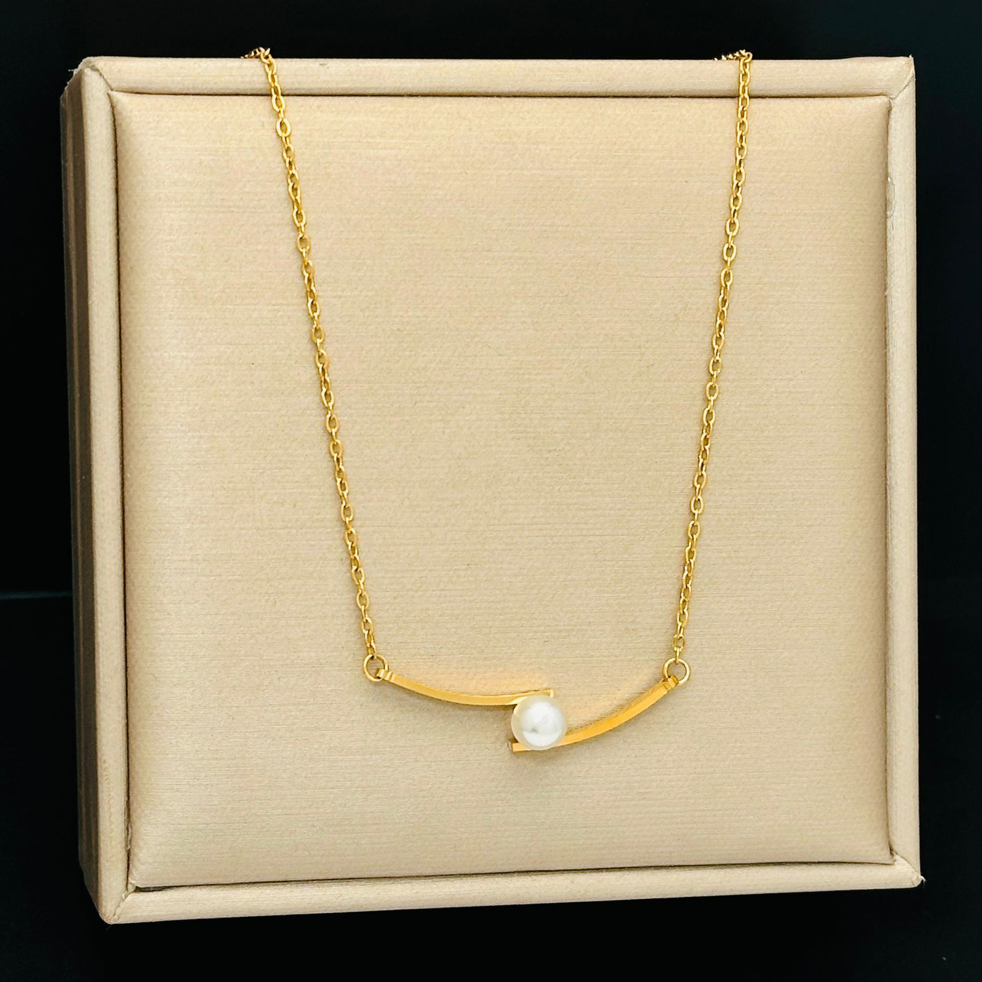 Elegant close-up of Opal Curve Necklace displayed on a velvet stand
