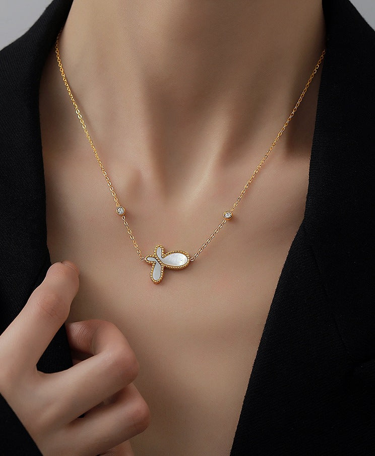 Elegant close-up of Butterfly Gleam Necklace displayed on a velvet stand