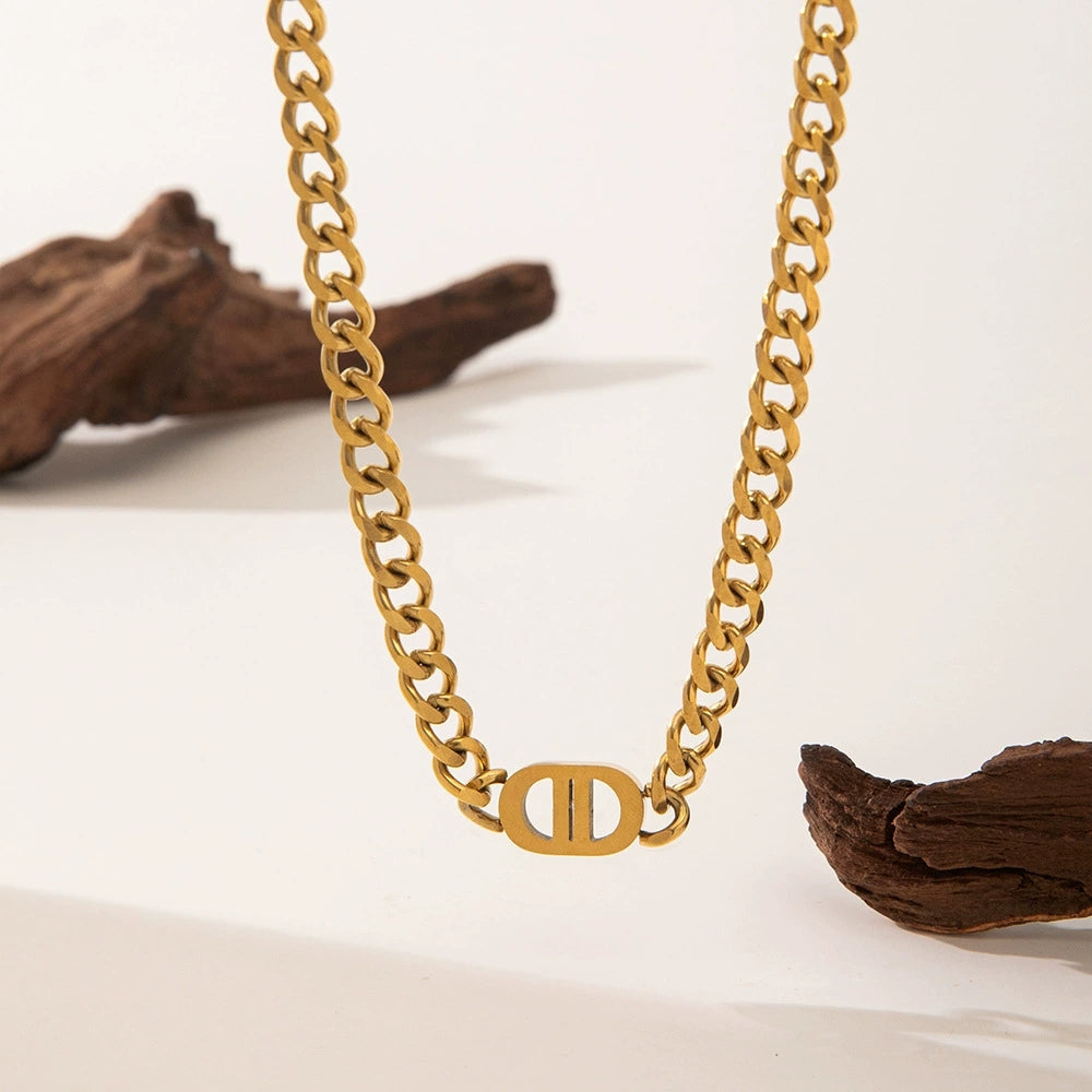 Elegant close-up of Auralin Emblem Chain displayed on a velvet stand