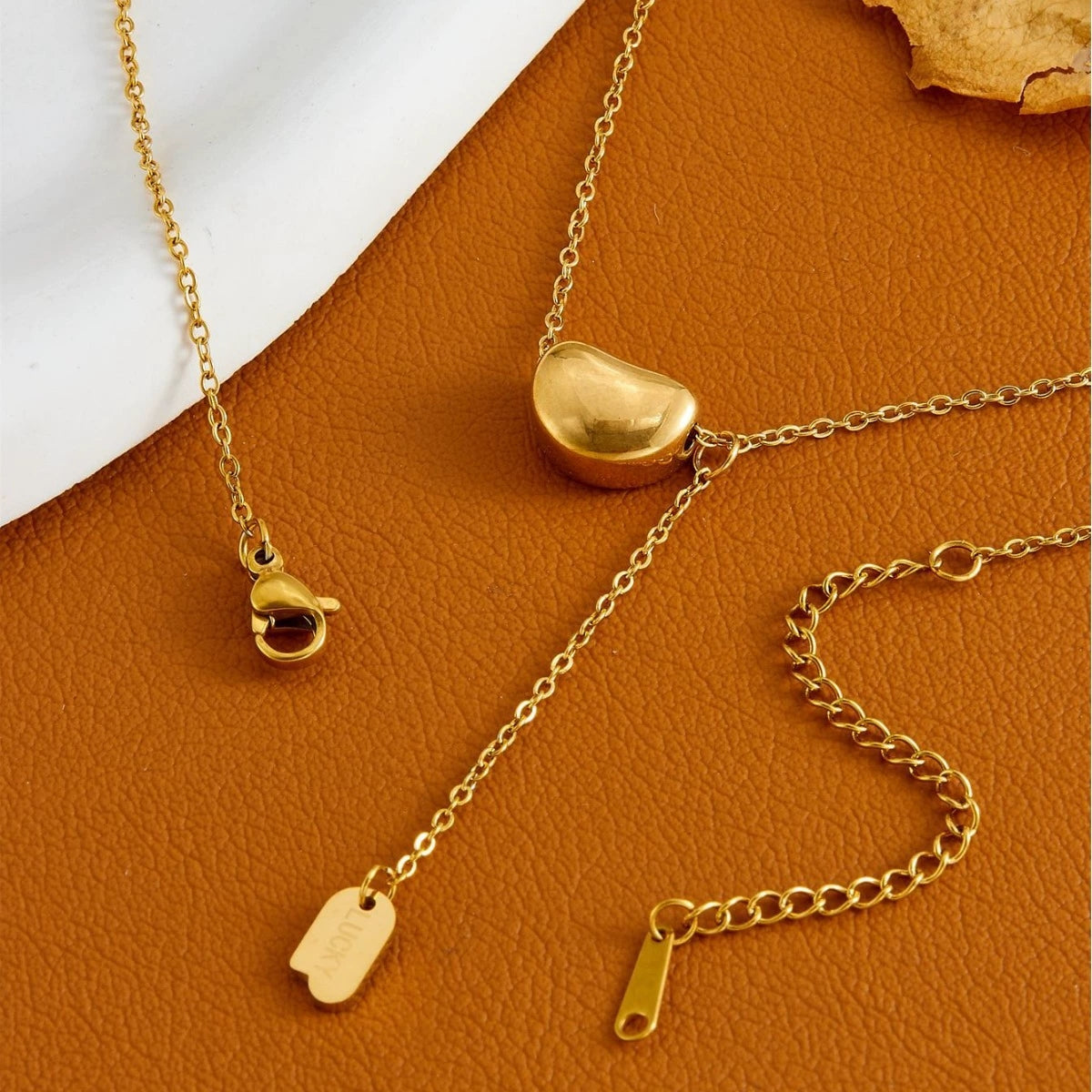 Elegant close-up of Luxe Line Necklace displayed on a velvet stand