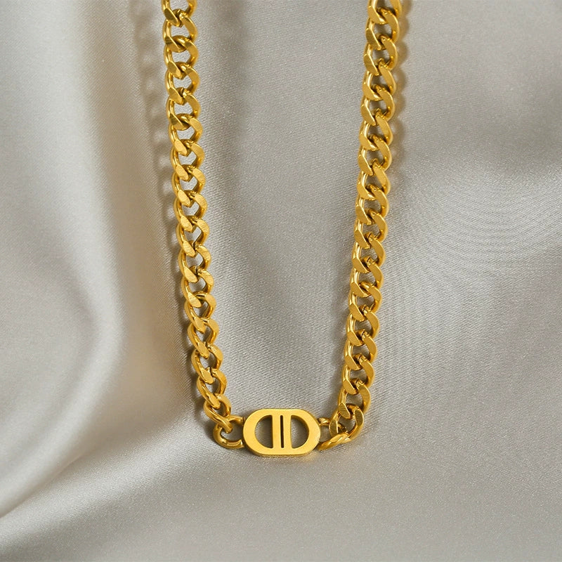 Elegant close-up of Auralin Emblem Chain displayed on a velvet stand