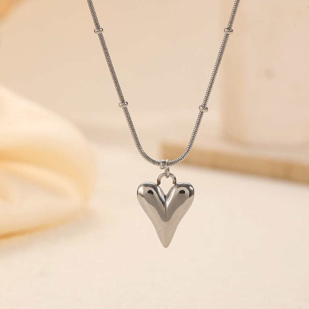 Elegant close-up of Lover's Silver Necklace displayed on a velvet stand