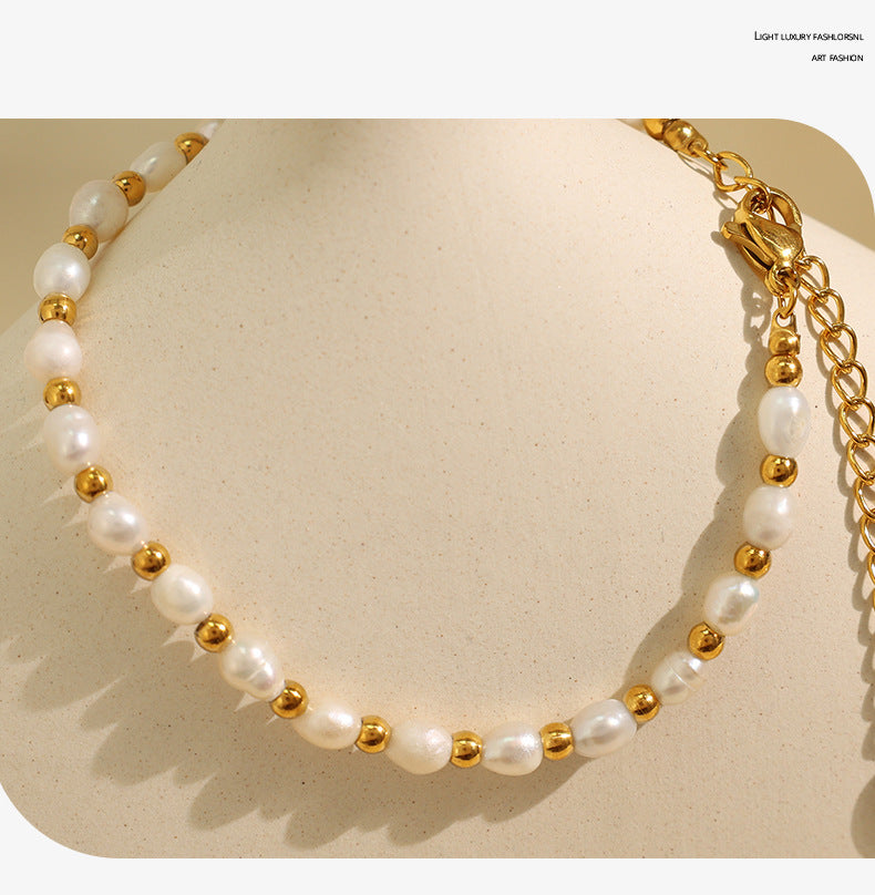 Elegant close-up of Celene Gold-Pearl Necklace displayed on a velvet stand