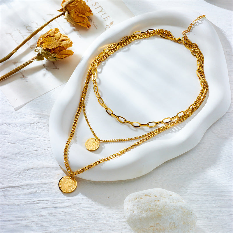 Elegant close-up of Aura Trio Necklace Set displayed on a velvet stand