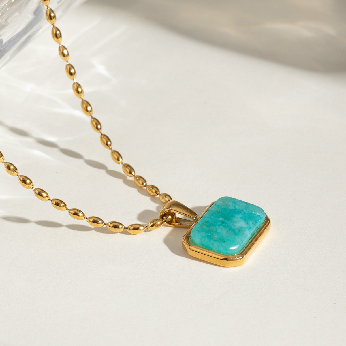 Elegant close-up of Oceanstone Necklace displayed on a velvet stand