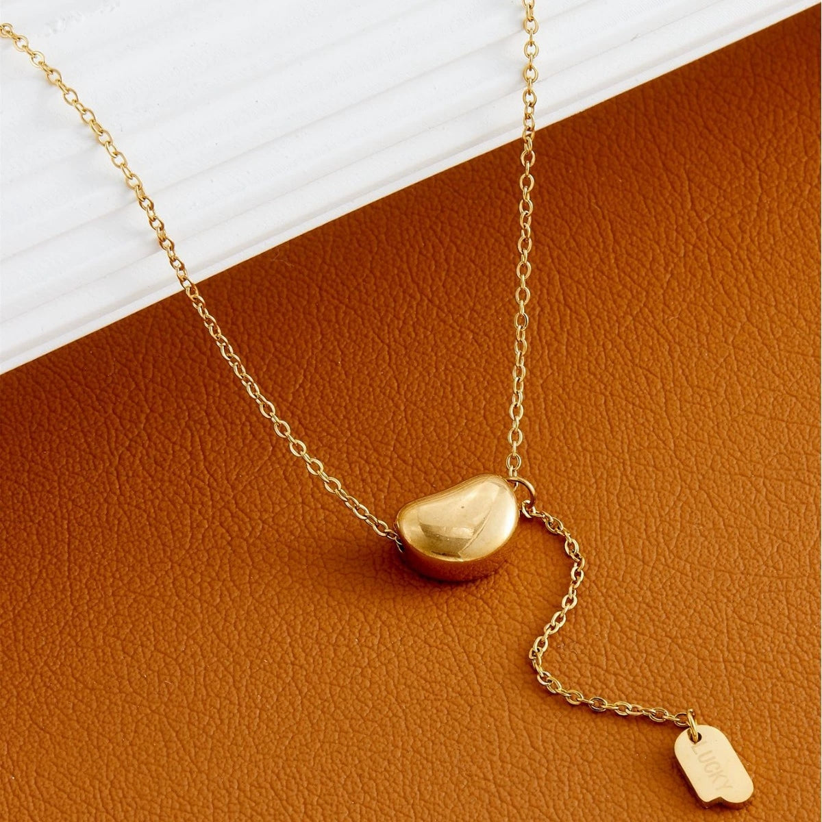 Elegant close-up of Luxe Line Necklace displayed on a velvet stand