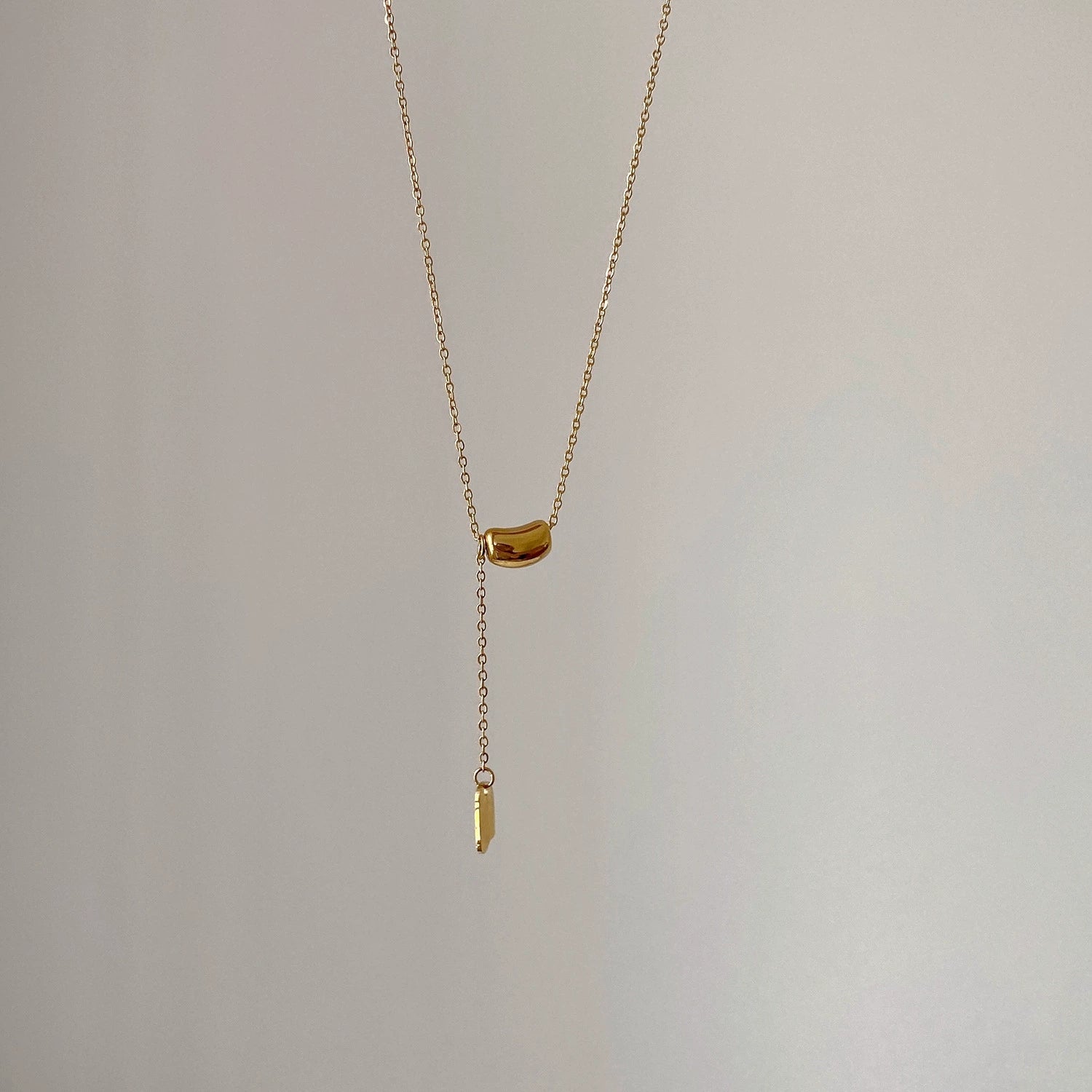 Elegant close-up of Luxe Line Necklace displayed on a velvet stand