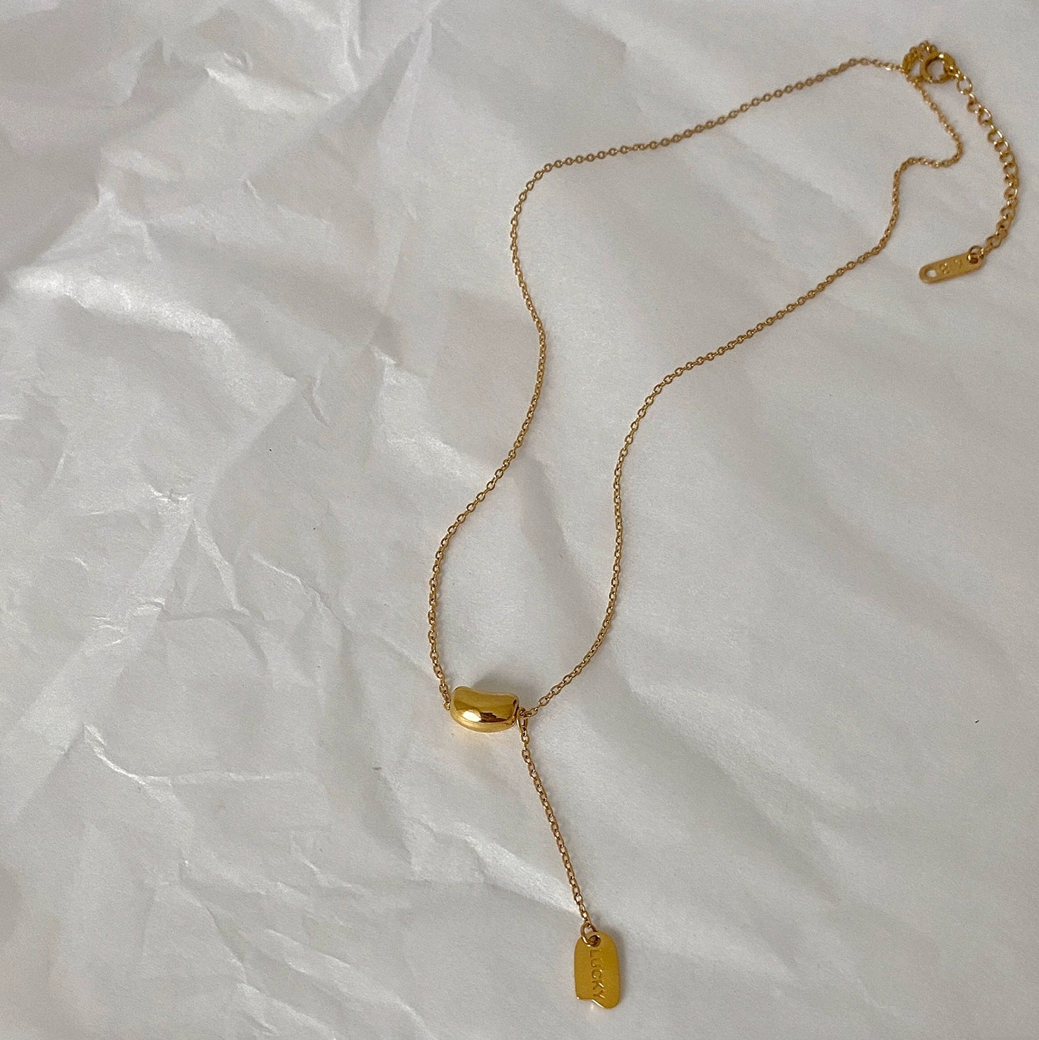 Elegant close-up of Luxe Line Necklace displayed on a velvet stand