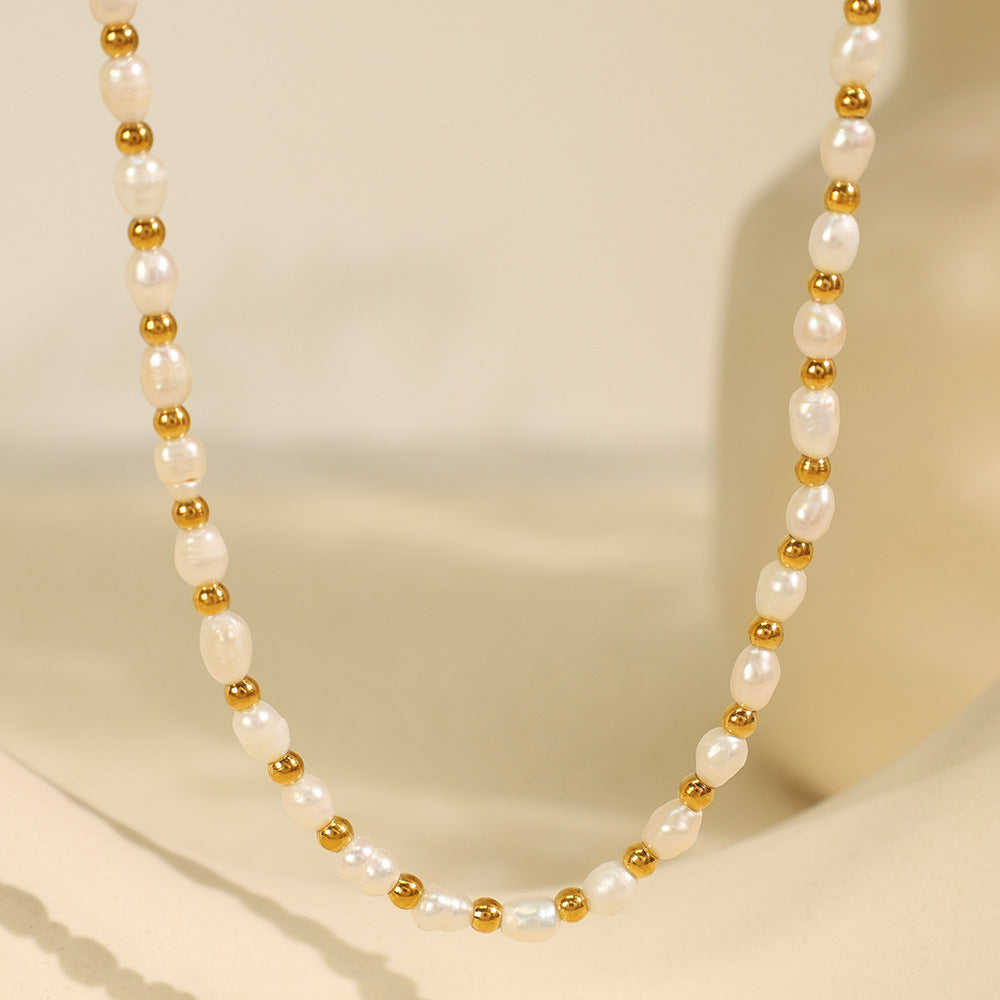 Elegant close-up of Celene Gold-Pearl Necklace displayed on a velvet stand