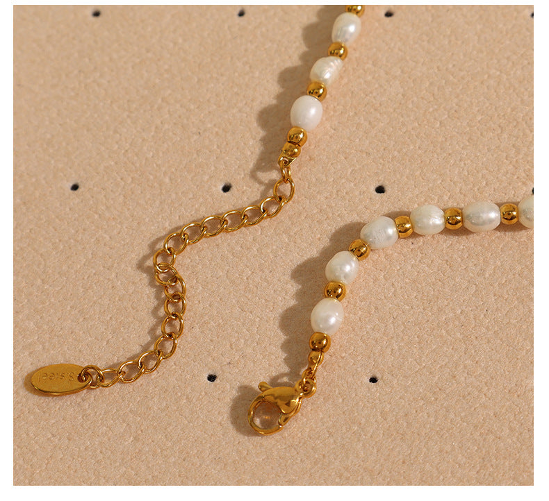 Elegant close-up of Celene Gold-Pearl Necklace displayed on a velvet stand