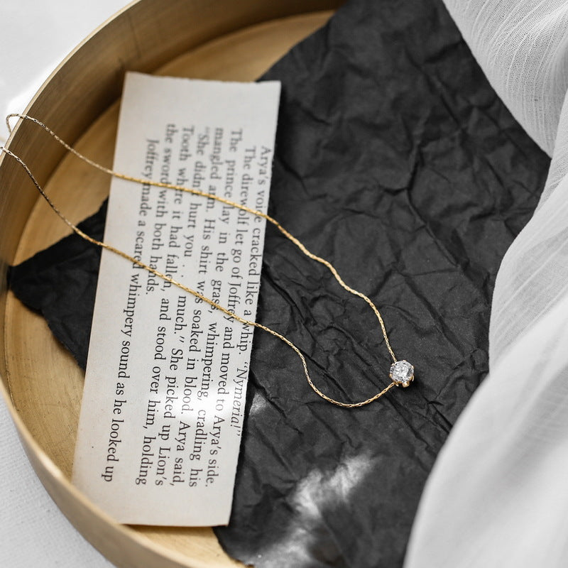 Elegant close-up of Sol Glow Necklace displayed on a velvet stand