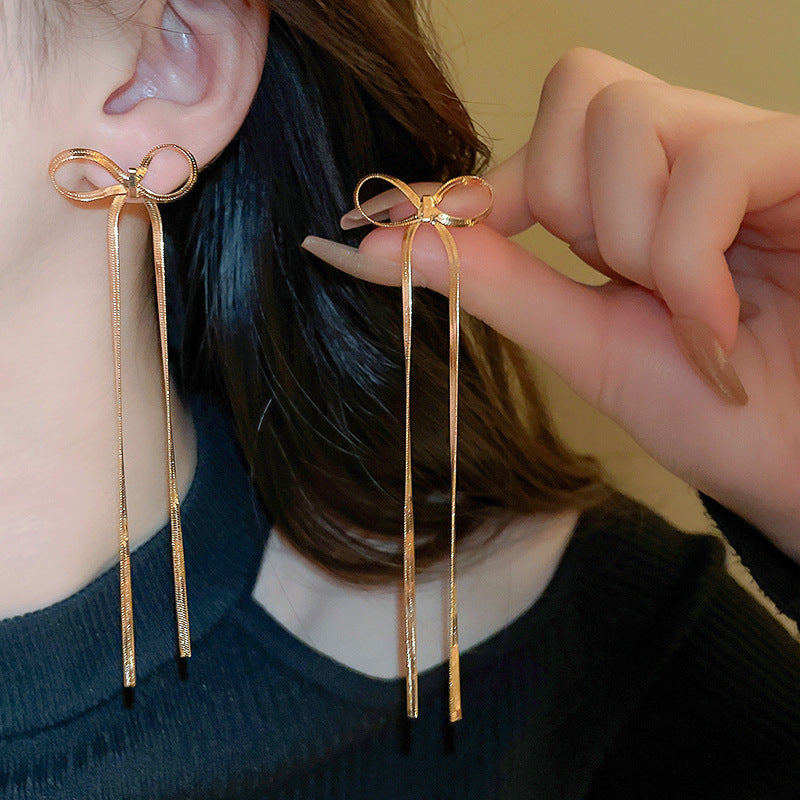 golden bow earrings in gold finish; stylish golden bow earrings for women