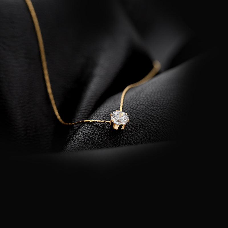 Elegant close-up of Sol Glow Necklace displayed on a velvet stand