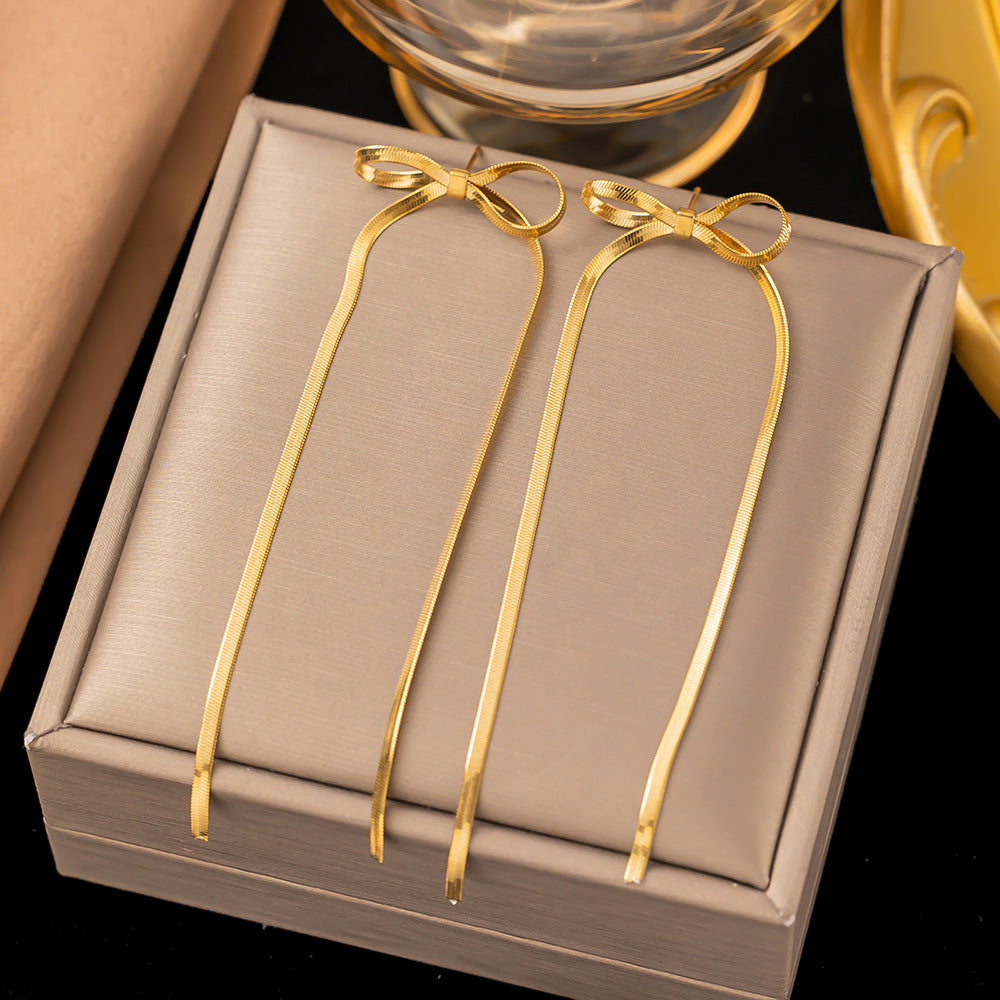 golden bow earrings in gold finish; stylish golden bow earrings for women