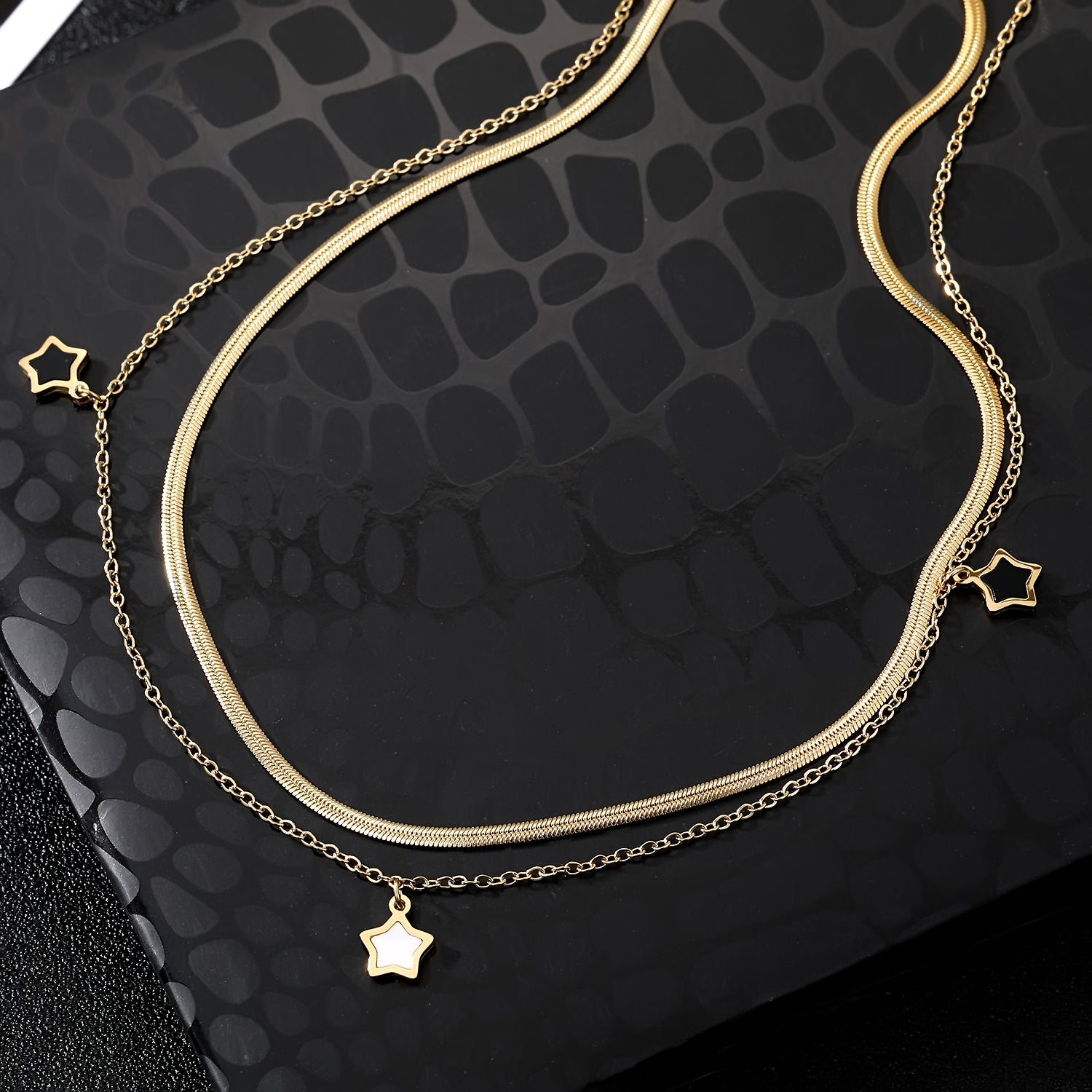 Elegant close-up of Stella Charm Necklace displayed on a velvet stand
