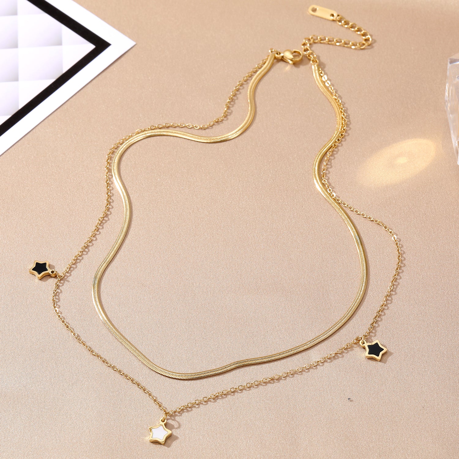 Elegant close-up of Stella Charm Necklace displayed on a velvet stand