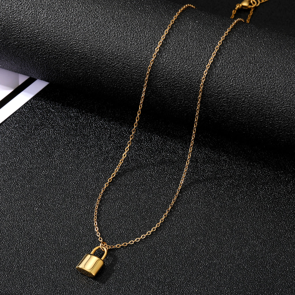 Elegant close-up of Golden Lockette Necklace displayed on a velvet stand