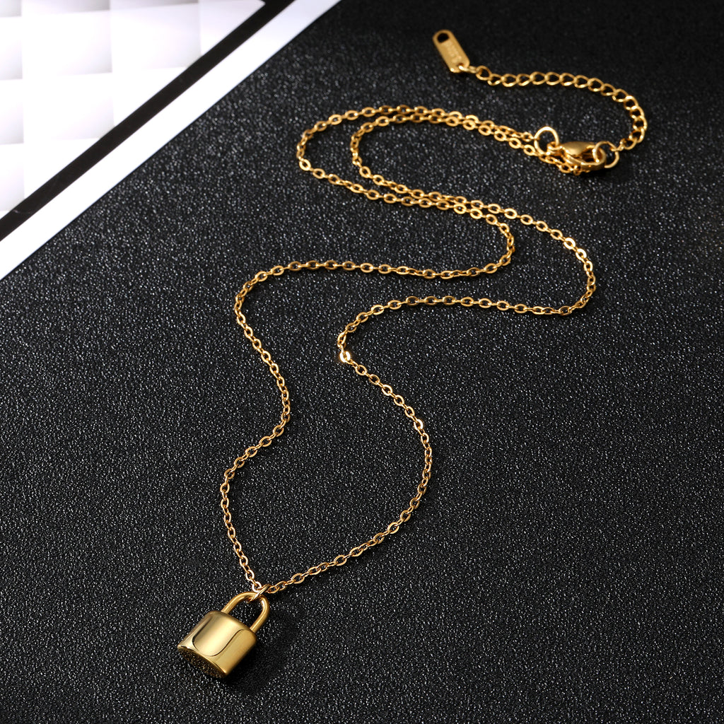 Elegant close-up of Golden Lockette Necklace displayed on a velvet stand
