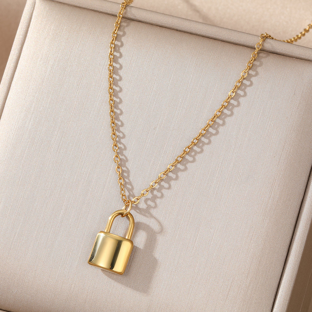 Elegant close-up of Golden Lockette Necklace displayed on a velvet stand