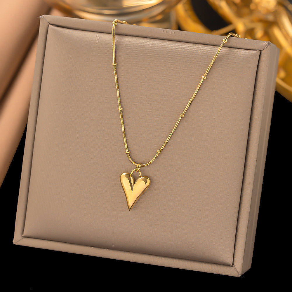 Elegant close-up of Loverâ€™s Curve Necklace displayed on a velvet stand
